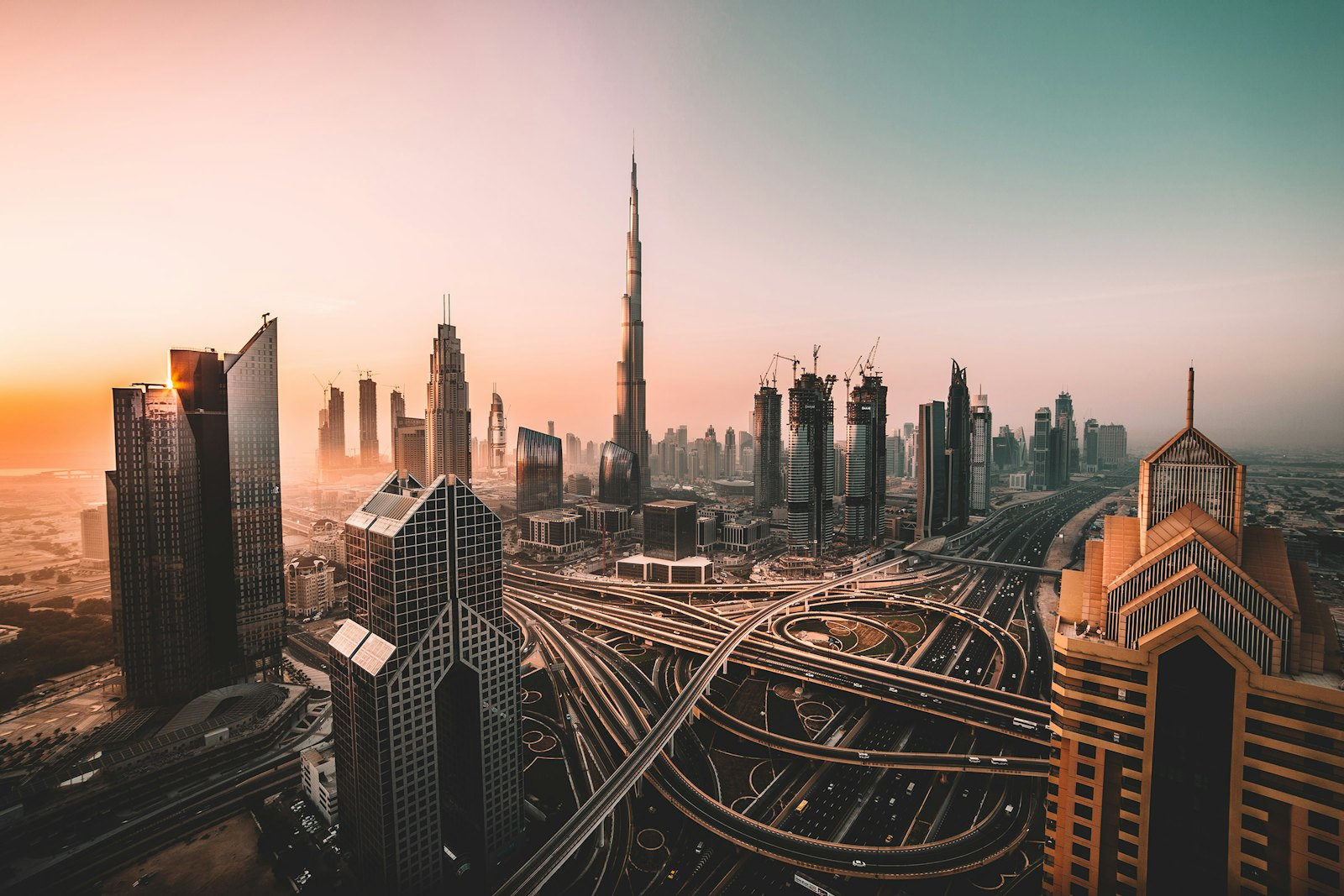 Downtown Dubai at sunrise with the Burj Khalifa above a web of highways