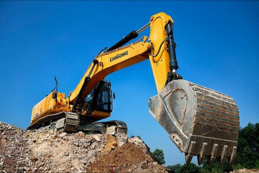 Yellow excavator against a blue sky