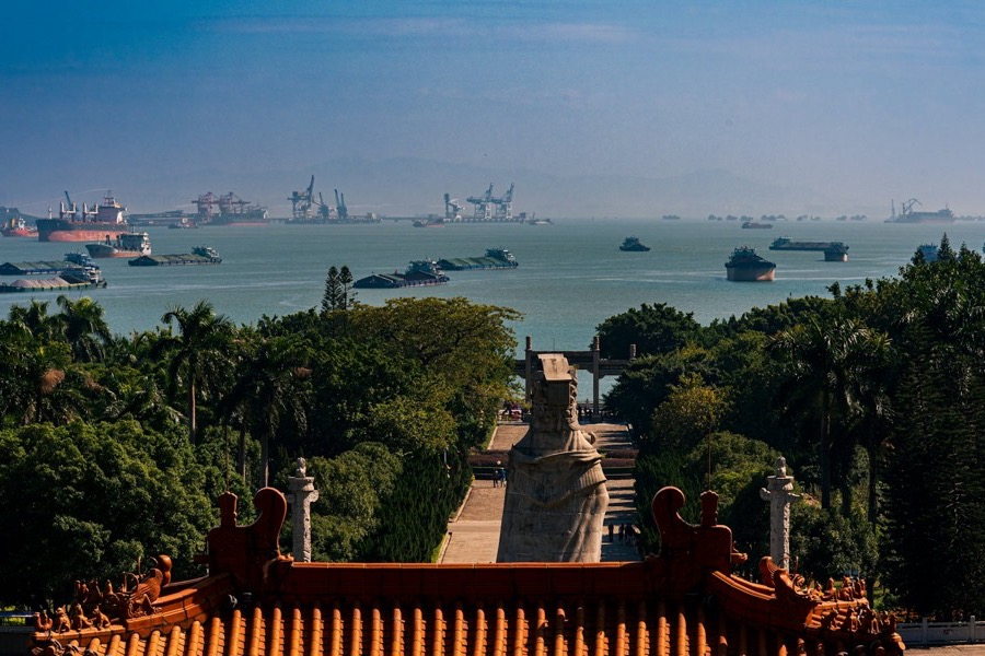Cargo ships and port cranes in Guangzhou harbour, China