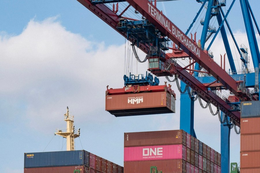 Crane lifting a shipping container onto a vessel